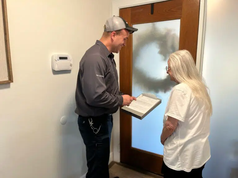Joe Potter reviewing pest control service contract with a residential customer
